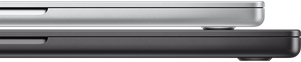 Closed 14-inch MacBook Pro in Silver finish, stacked on closed 16-inch MacBook Pro in Space Black finish.