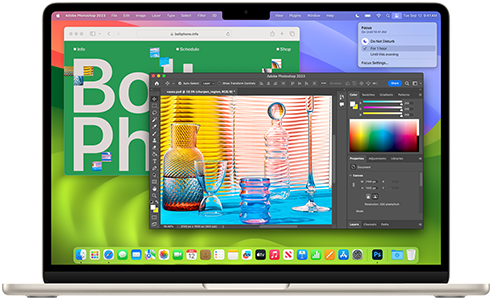 Open 13-inch MacBook Air in Starlight finish, screen showcasing Safari and Photoshop apps to demonstrate the capability of Apple silicon.