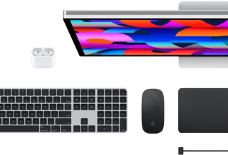 Top view of Mac accessories: Studio Display, AirPods, Magic Keyboard, Magic Mouse and Magic Trackpad