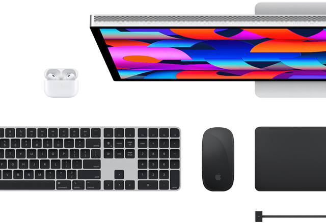 Top view of selected Mac accessories: Studio Display, Magic Keyboard, Magic Mouse, Magic Trackpad, AirPods and MagSafe charging cable