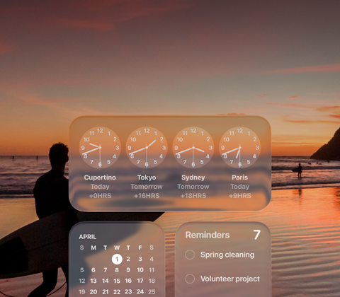 Liquid Glass Clock, Calendar, Reminders and Weather widgets on macOS Tahoe screen over a scene of a surfer walking on the beach at sunset