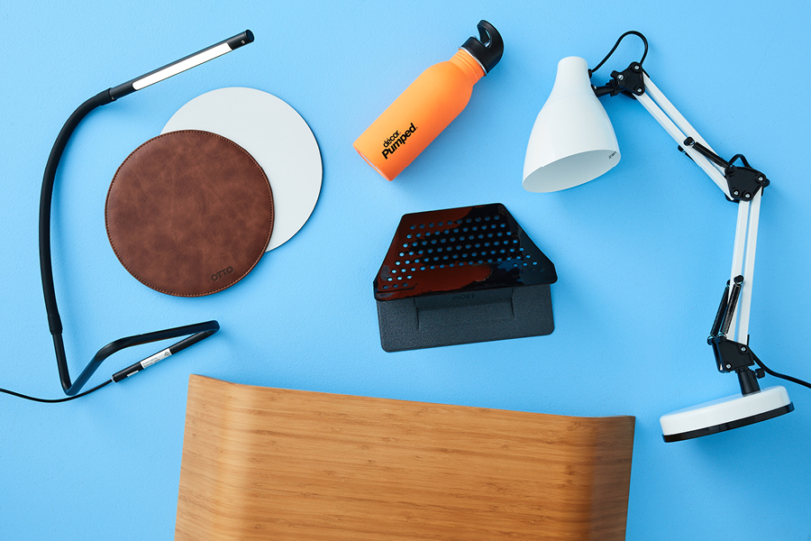 Home office desk essentials include good lighting and a laptop riser.